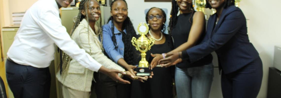 The University of Nairobi's Faculty of Law (FOL) Kenya Model United Nations (KMUN) team  pose for a photo with the dean Prof. Winfred Kamau